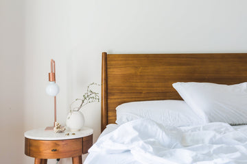 Minimalistic Bedroom with Two White Pillows and Duvet on Bed and a Scandinavian Design Nightstand